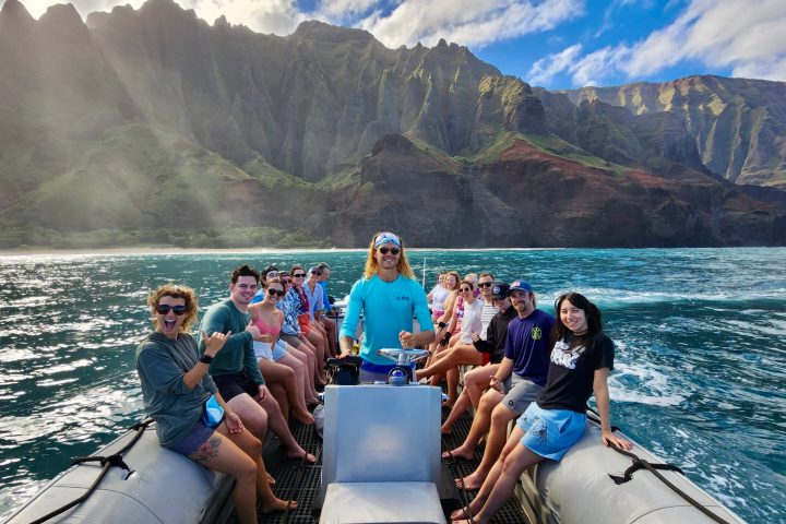 Boat tour passengers having a good time in front of The Kalalau Cathedral Cliff