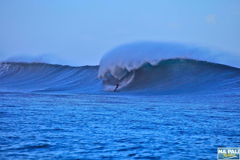 a man riding a wave on top of a body of water