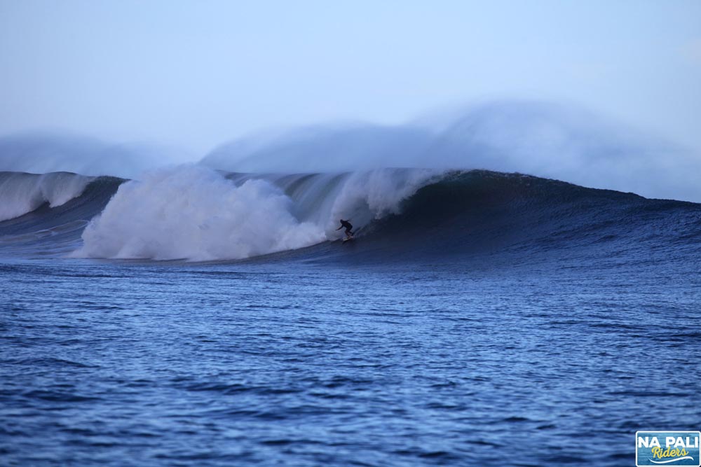 a man riding a wave on top of a body of water