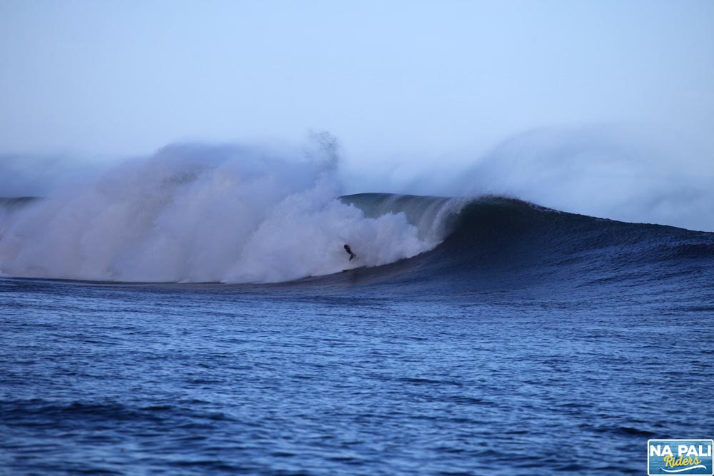 a man riding a wave on top of a body of water