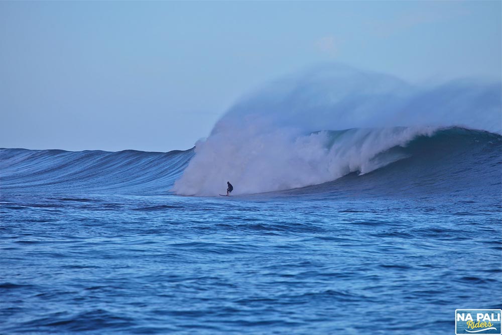 a man riding a wave on top of a body of water