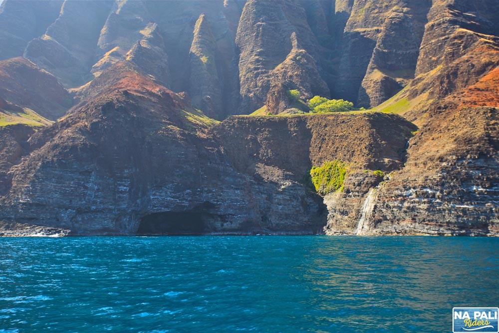 a large body of water with a mountain in the background