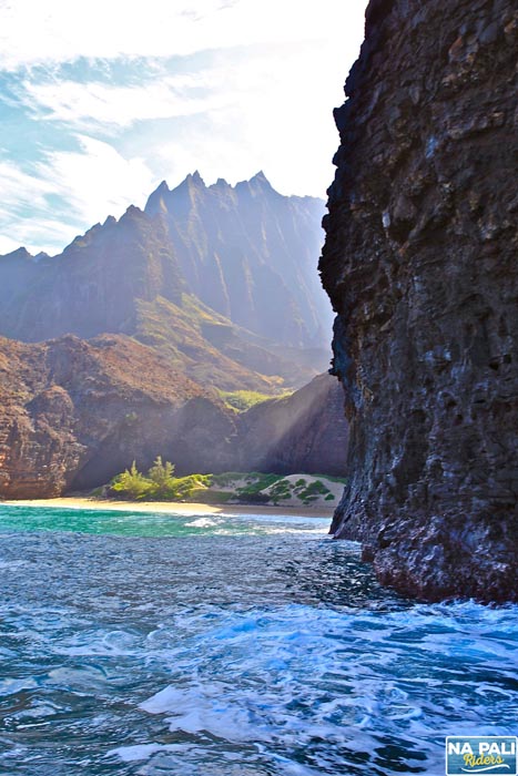 a body of water with a mountain in the background