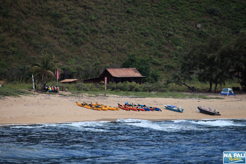 a group of people standing next to a body of water