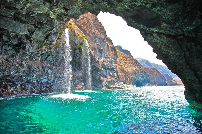 a large waterfall over some water