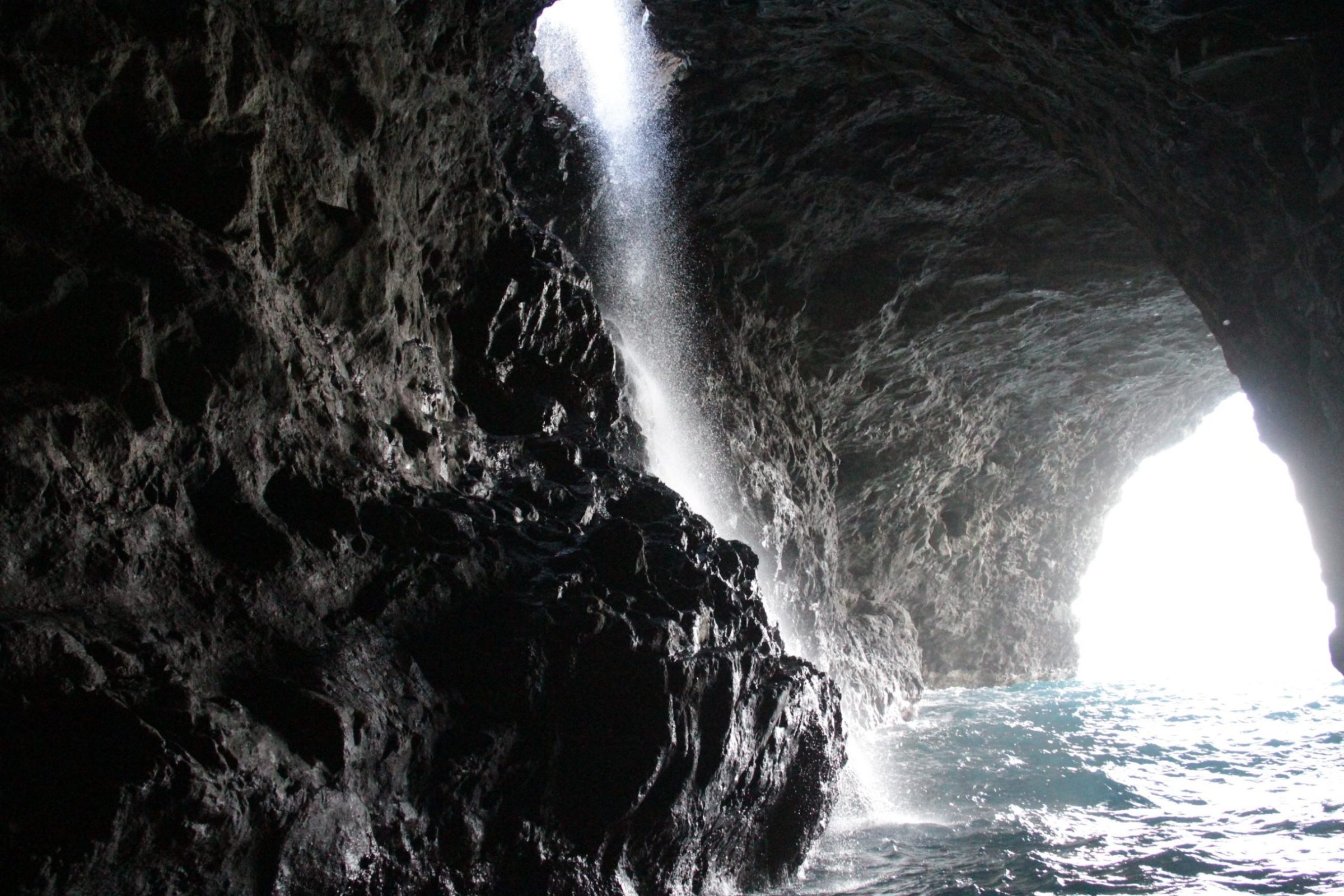 a large waterfall over some water