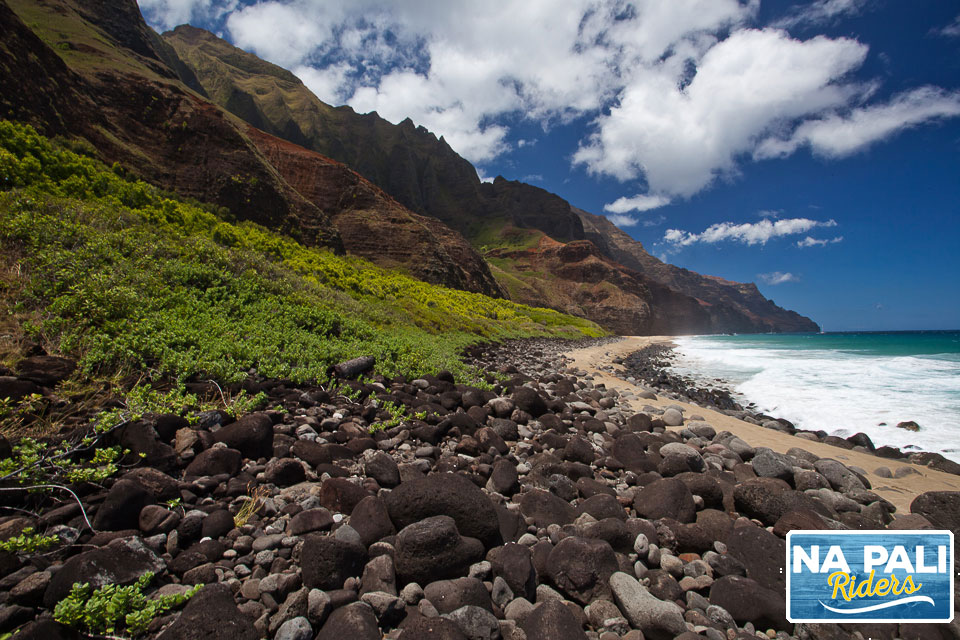 a rocky beach next to a body of water