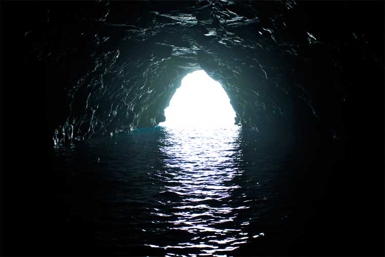 a tunnel with water in the dark