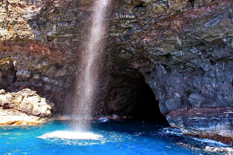 a large waterfall over some water