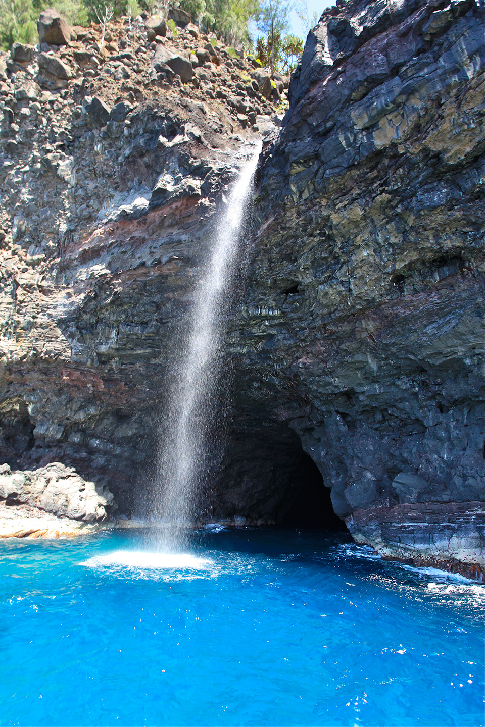 a large waterfall over a body of water