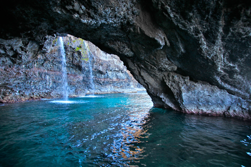 a large waterfall over some water