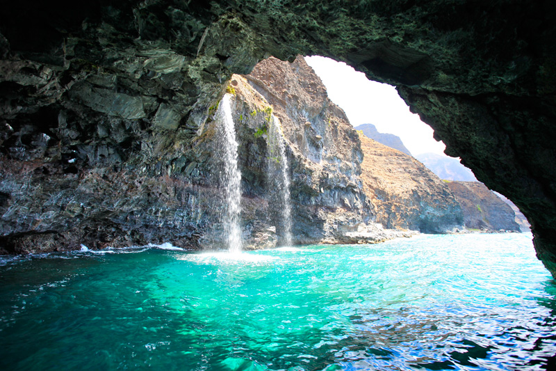 a large waterfall over a body of water